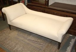 A late Victorian/Edwardian mahogany day bed, circa 1900, upholstered in white calico, on ring turned