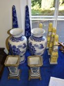 Four modern Far Eastern porcelain yellow-ground obelisks; a pair of similar and larger blue