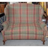 A high backed sofa in tartan style upholstery