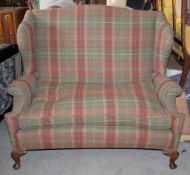 A high backed sofa in tartan style upholstery