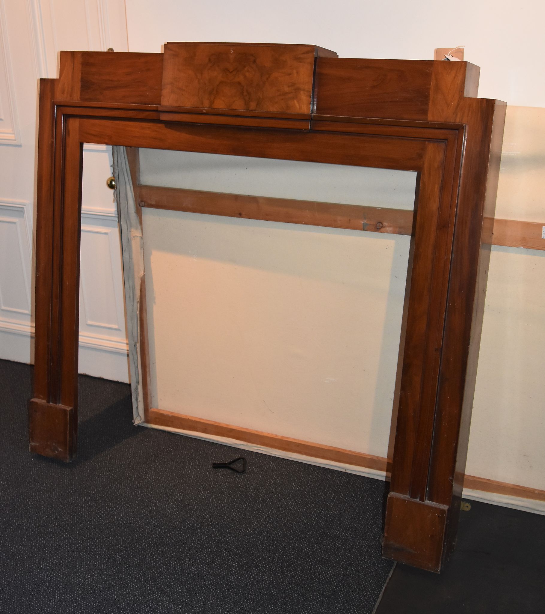 An Art Deco walnut veneered chimney piece, circa 1930,