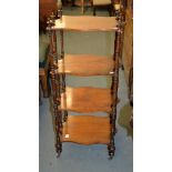 A Victorian mahogany four tier whatnot, with turned supports between each tier, 113cm high