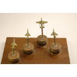 A Trench Art Desk Ornament made from Cartridge Shells with Miniature Fighter Jets Mounted Upon