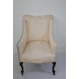 An Edwardian Small Armchair on Casters