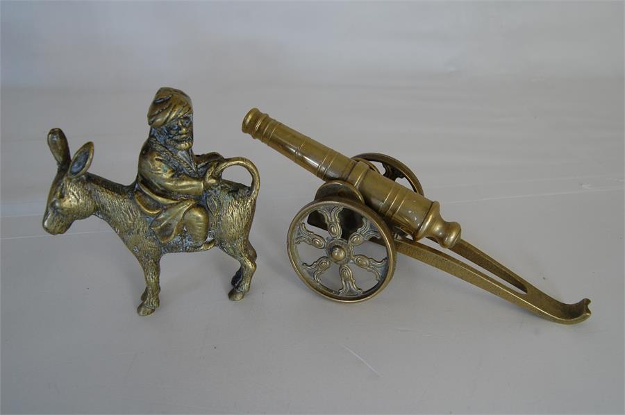 Small Brass Cannon on Brass Carriage together with a Brass Seated Man Rear Facing on a Donkey