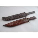 A Pair of Reproduction Carved Tribal Sheathed Knives