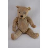 A Vintage Faded Yellow, Firmly Stuffed, Articulated Teddy Bear