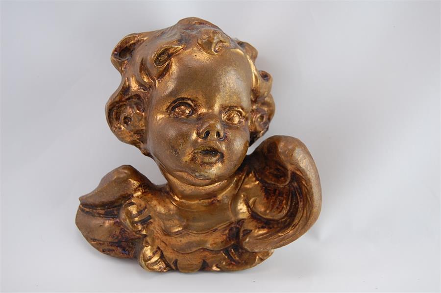 A Continental Gilded Head of a Putti