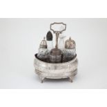 Geo III S/S Bottle Stand oval shape with fixed handle, bright cut engraving on four scroll feet,