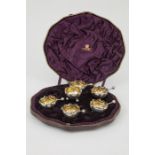 Cased Set of Eight Victorian S/S Circular Salts with waved rims on three ball feet, with spoons