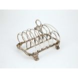 Geo III S/S Toast Rack with fixed loop handle, six arched divisions on gadrooned base with shell