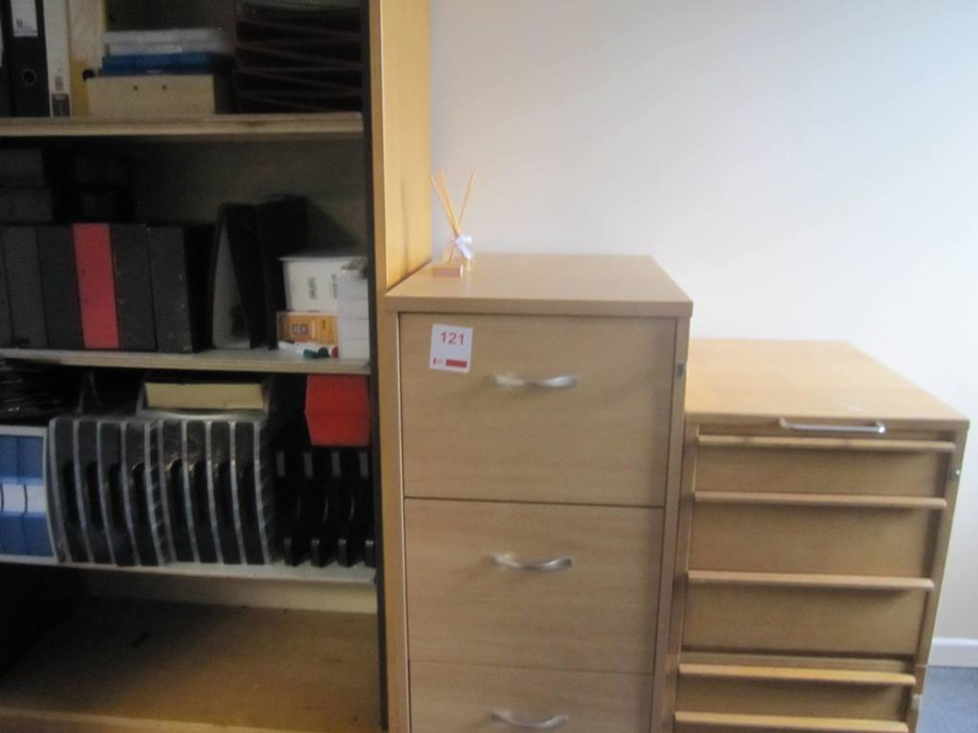 Three items of light oak effect office furniture including roller door cupboard, 3-drawer filing