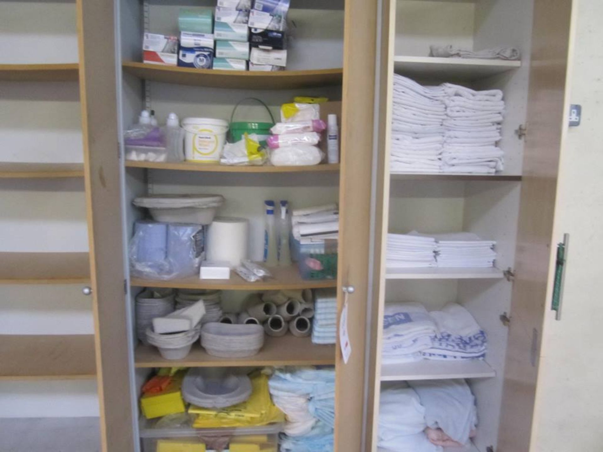 Loose contents of two cupboards, including linen (sheets, towels), consumable stock, etc.