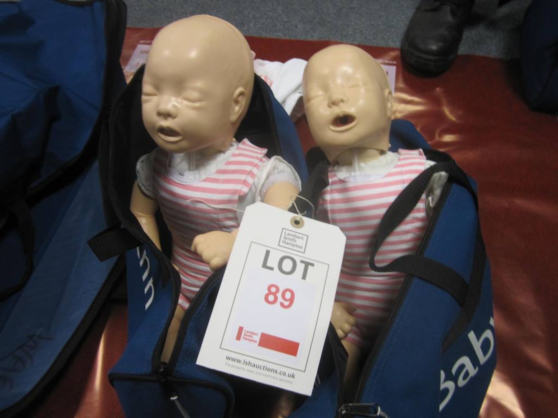 Two Laerdal Baby Annie CPR training manikins and two carry cases