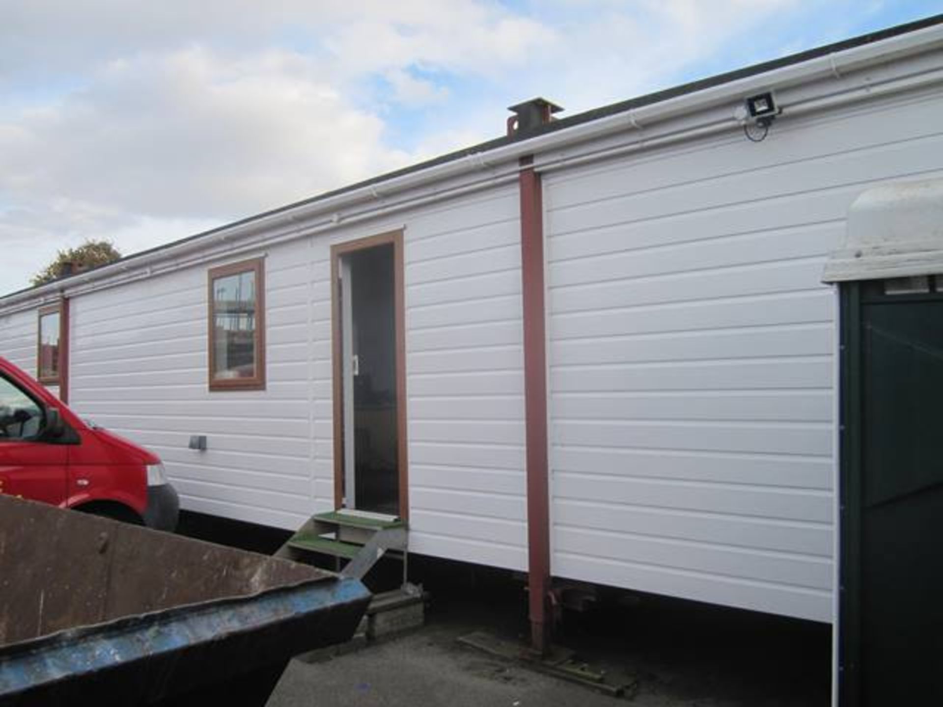 Plastic cladded jack leg site office, approx 14m x 3.5m,10 recently fitted PVC windows, Fitted black