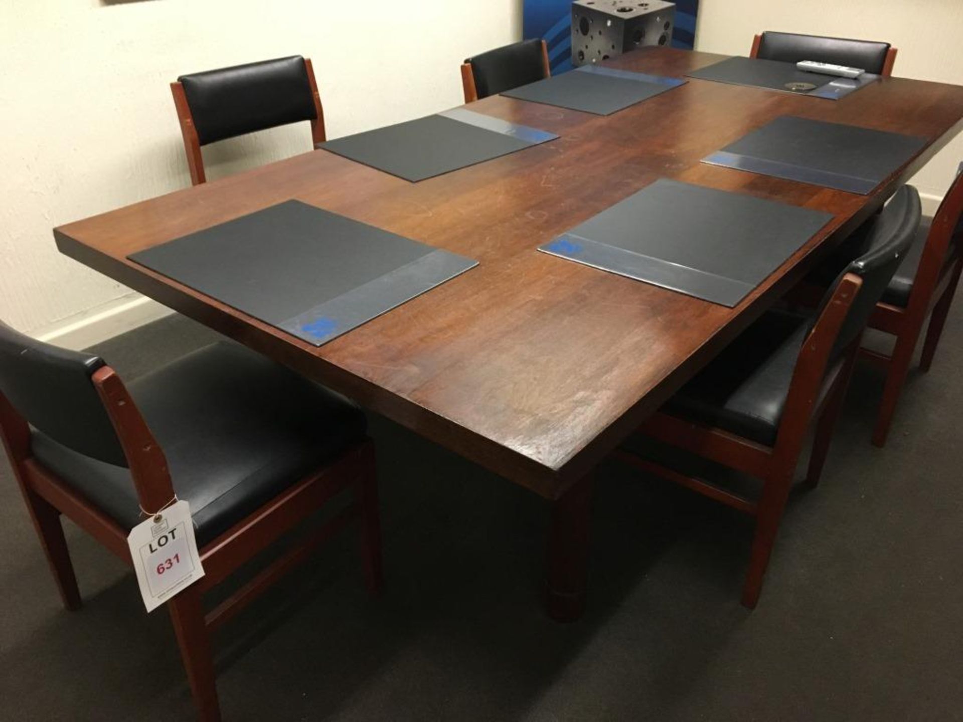A wood veneer meeting table, 96" x 48", with seven chairs and six black desk mats (Please note: