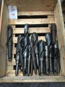 Sixteen HSS tapered shank drill bits and three sleaves