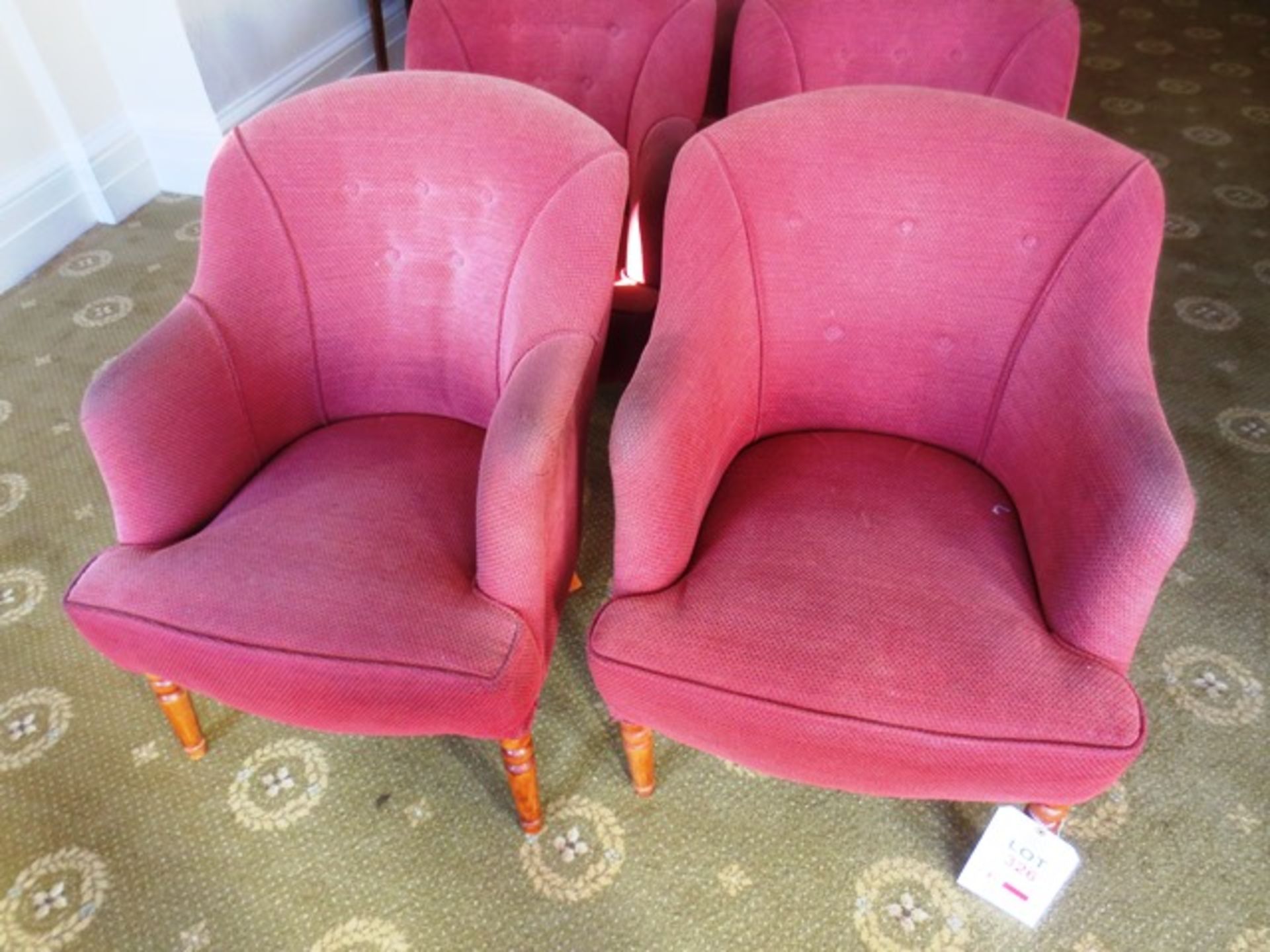 Two red cloth upholstered tub chairs (Please note: image for illustrative purposes only)