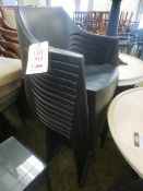 Fourteen black plastic stackable chairs
