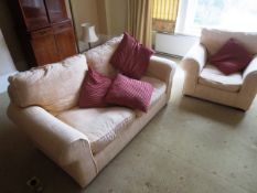 Cream cloth upholstered two-seater sofa and two matching arm chairs