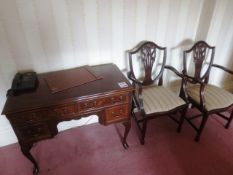 Two dark-wood chairs and dark-wood 4-drawer desk