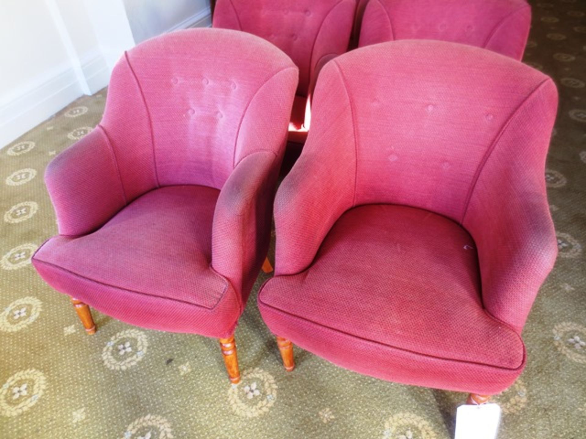 Two red cloth upholstered tub chairs (Please note: image for illustrative purposes only)