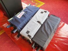 Three collapsible travel cots