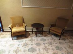 Two cream cloth upholstered , dark-wood framed arm chairs and dark-wood table