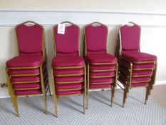 Twenty steel-framed red cloth upholstered stackable chairs
