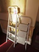 Two collapsible step ladders