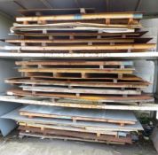 Quantity of assorted steel plates on three shelves as lotted (excludes rack)