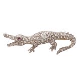 An antique jewelled crocodile brooch in yellow gold and platinum / silver, modeled as a crocodile in