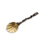 An antique German 800 Silver gilt serving spoon by A Roesner, c1890. The shell decorated bowl with a