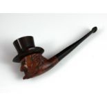 An antique meerschaum smoking pipe carved to depict a wizened gentleman wearing an American Uncle