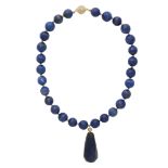 A lapis lazuli bead necklace formed of twenty eight faceted carved lapis lazuli beads with spherical
