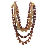 Five amber bead necklaces in varying styles.