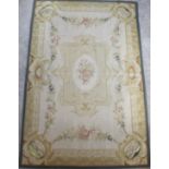 An antique cream ground rug / carpet, with central floral medallion within floral reserves in a