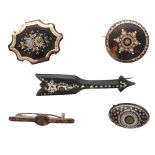 A collection of five antique brooches to include two wooden brooches with silver pique and mother of
