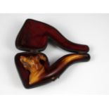 A novelty antique meerschaum smoking pipe carved to depict the head of a dog / hound, with a natural