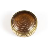 An antique late 18th Century gold and horn snuff box, French or English, of circular form with domed