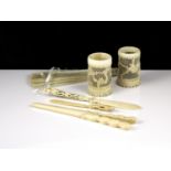 A collection of antique late 19th century ivory items to include a pair of carved brush pots, a pair