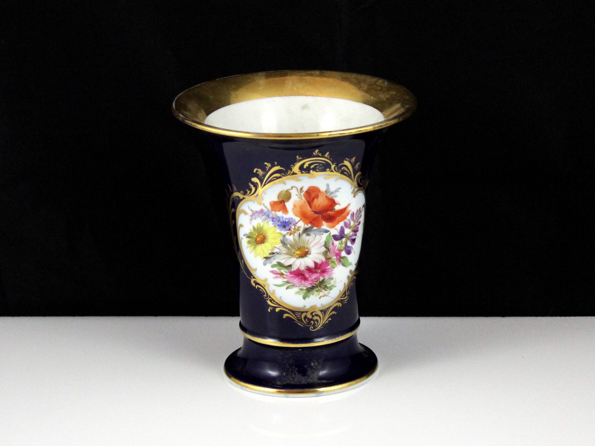 An antique late 19th / early 20th Century Meissen porcelain vase, of tapering form with a flared