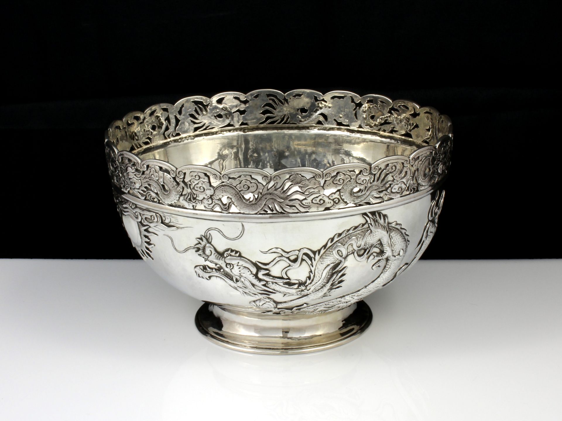 An antique Qing dynasty Chinese export Silver dragon bowl by Wang Hing & Co of Hong Kong circa 1890.