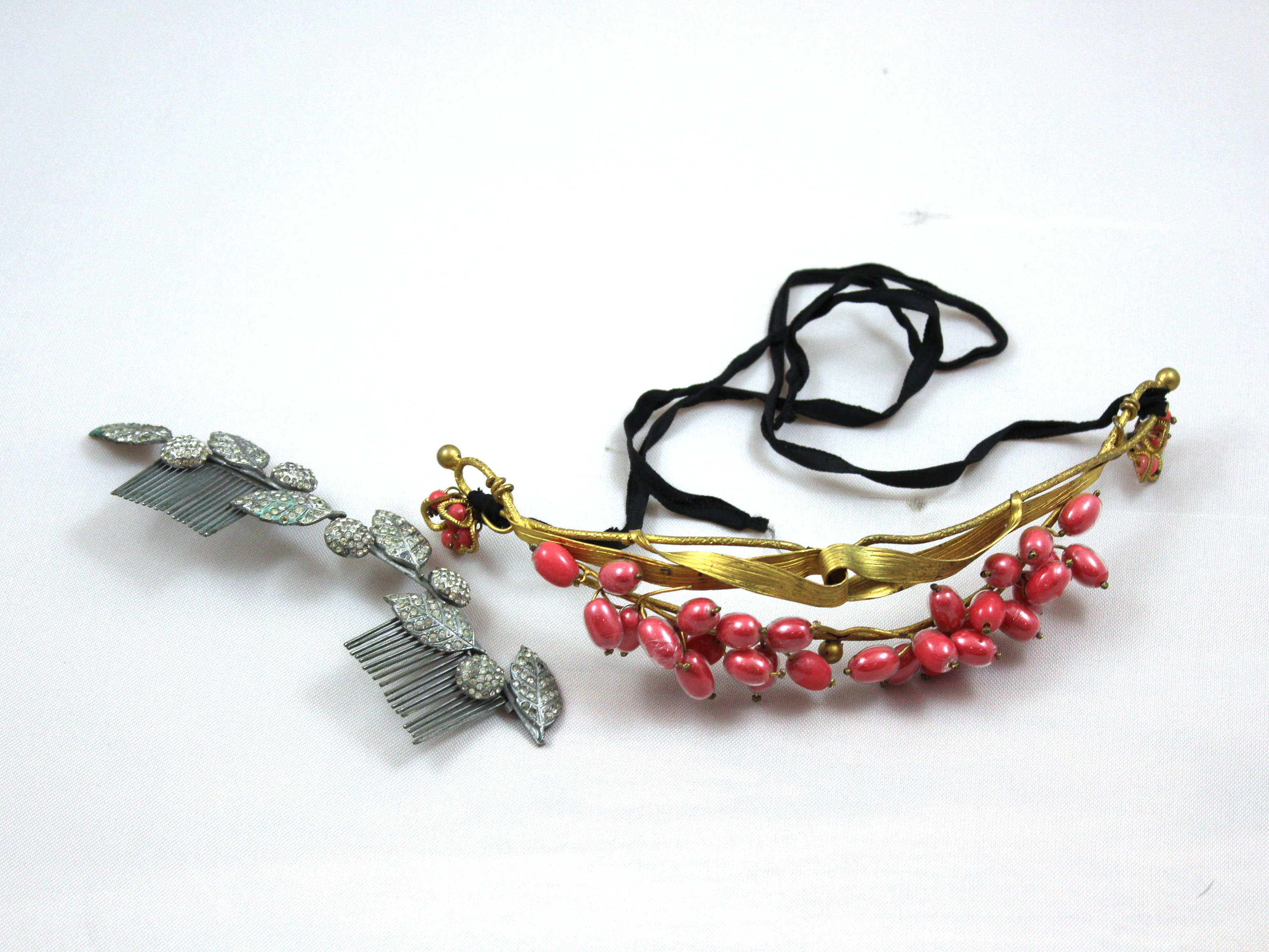 A gilt metal tiara with red oval beads together with a white metal and marcasite hair comb featuring