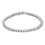 A diamond line / tennis bracelet in 18ct white gold, set with fifty five round brilliant cut