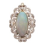 An antique opal and diamond pendant in gold, the large central cabochon opal weighing