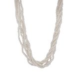 A cultured pearl necklace comprising six strands of pearls intertwined around one another with