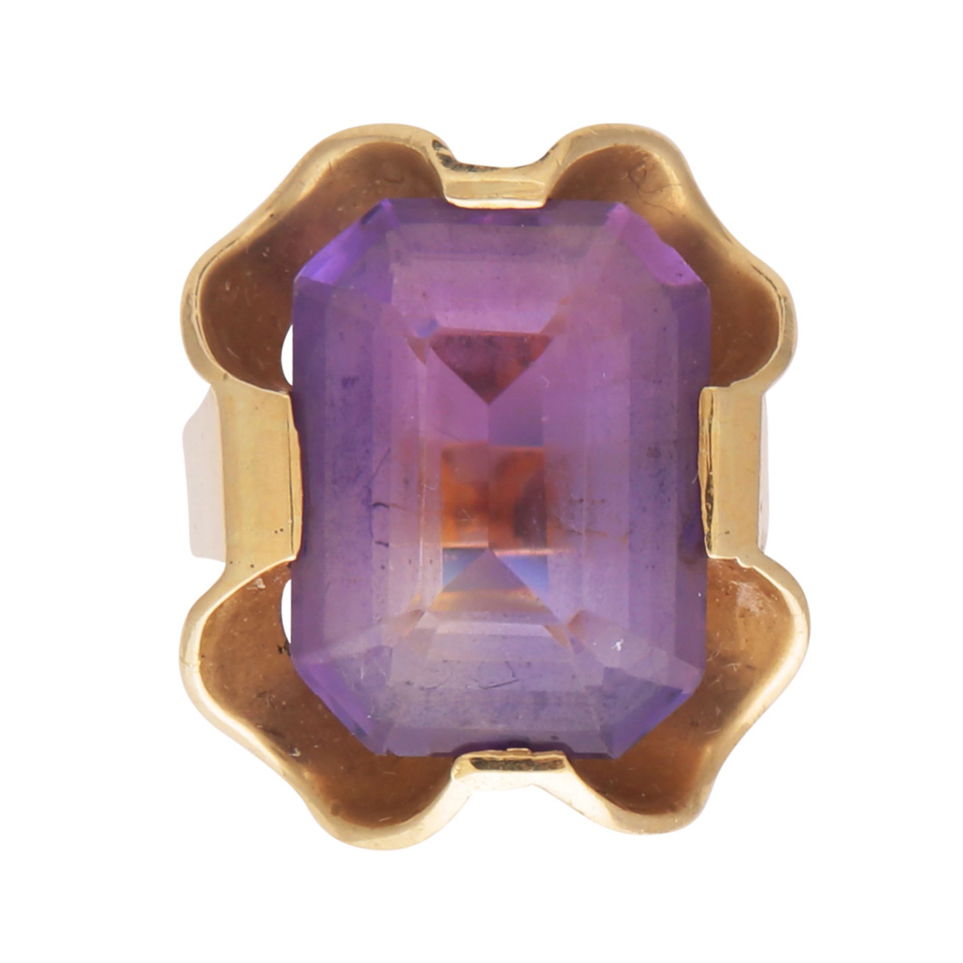 An antique amethyst dress ring probably German, in 14ct yellow gold, the emerald cut amethyst