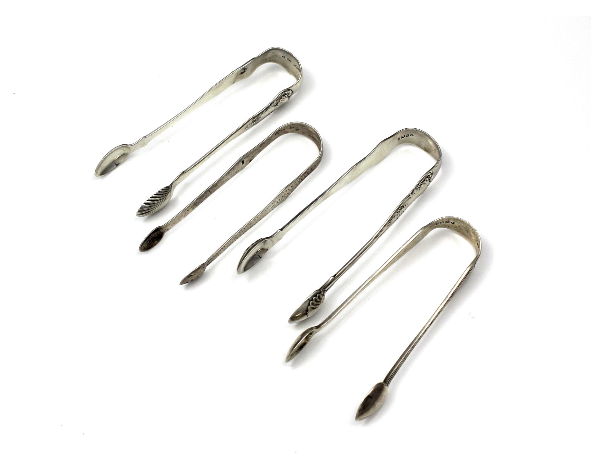 Four pairs of Antique Georgian & Victorian Sterling Silver sugar tongs to include two pairs by