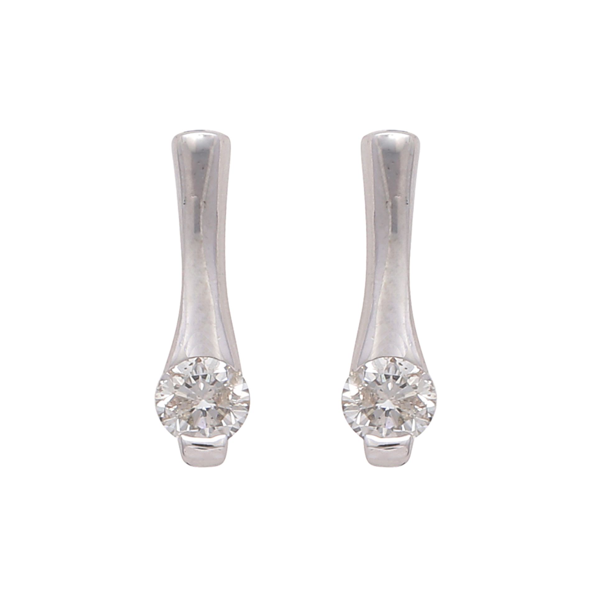 A pair of diamond stud earrings in white gold each designed as a round cut stone set at the bottom